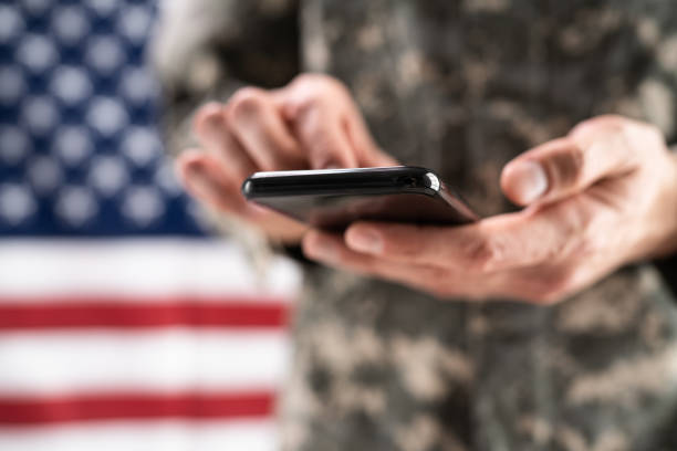 istock Soldier Holding Mobile Phone 1415932646