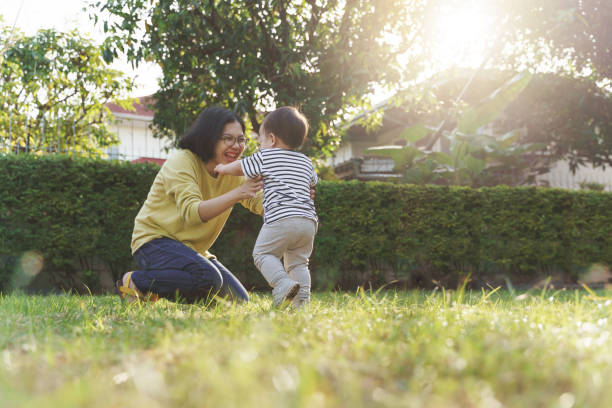 istock Little boy running into Chinese mom embrace 1415935973