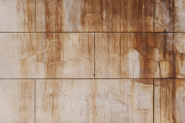 An old concrete block wall with stains.