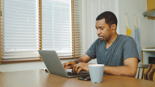 istock Black African American man using laptop 1415937797