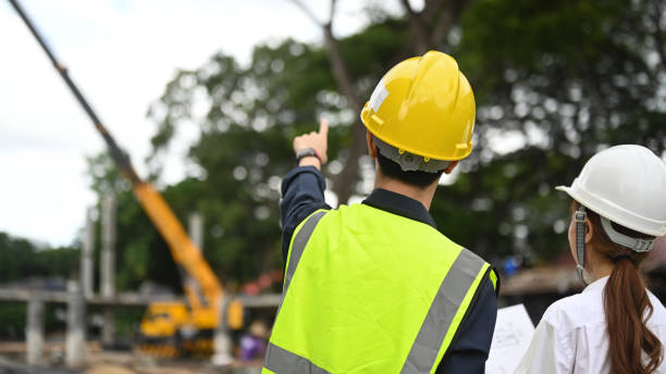 istock Rear view of civil engineers and specialists checking plan at construction site. Industry, Engineer, construction concept. 1415938452