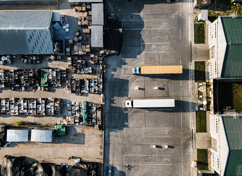 Small Logistics and Distribution Center with parked trucks from above