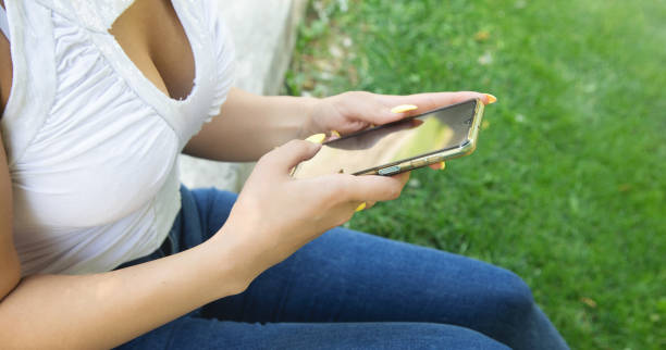 istock Young woman using mobile phone in outdoors. 1415939068