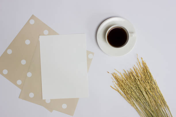 istock Paper with coffee cup and brown wheat over the white background. 1415939187