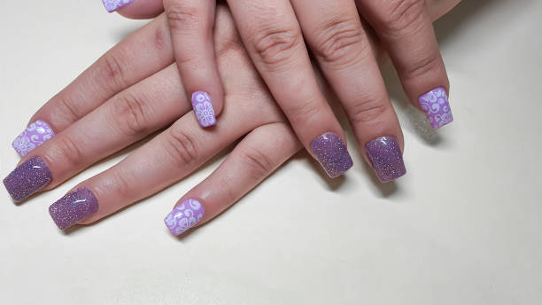 istock Acrylic nail extension, manicure, nail correction, hands in the foreground. 1415939957