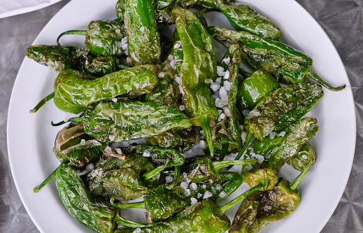 Pimientos de Padrón are peppers that are grown around the town of Padrón in Galicia. Fried in olive oil and sprinkled with coarse salt, this dish has become very popular throughout Spain.