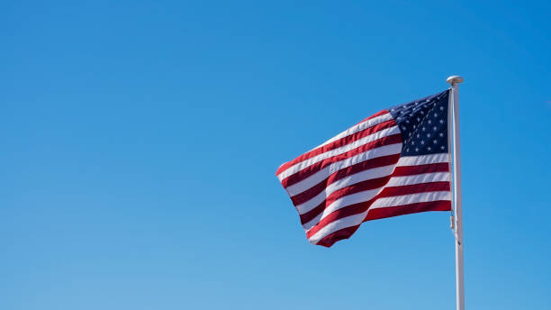 istock American flag raised against clear blue skies 1415945052