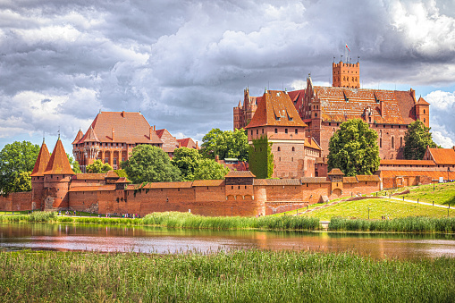 Malbork, Poland - August 07, 2022: Medieval capital of the Teutonic Knights, gothic brick castle Malbork in Poland. Popular tourist attraction and UNESCO heritage site