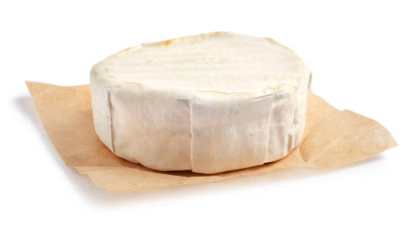 istock Parchment with delicious brie cheese isolated on white 1415945801