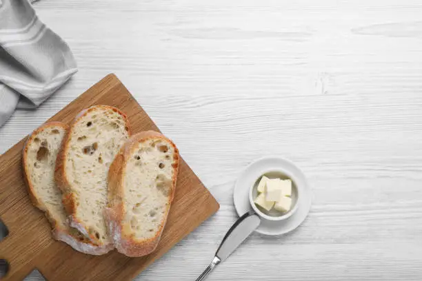 Flat lay composition with freshly baked sodawater bread on white wooden table. Space for text