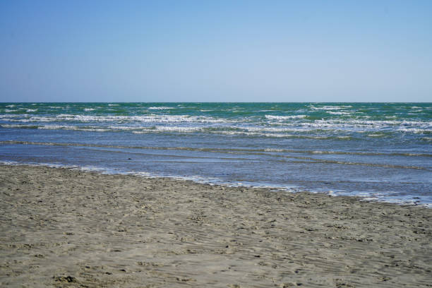 istock View of the ocean lapping on a sandy shore 1415946576