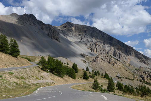 A sunny spring day in the French Alps where a signpost at the highest point along the Col de L'Iseran ( 2770 m) indicates the route to different directions. Popular area for cyclists, motorcyclists and road trips by car.