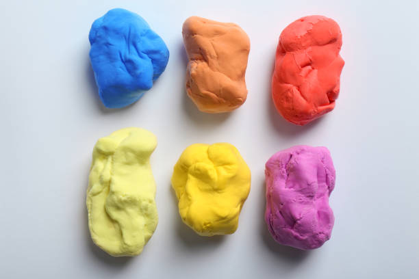 istock Different color play dough on white background, top view 1415949302