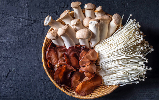 Top view of ear mushroom or black jelly fungus ,golden needle mushroom,Royal Oyster Mushroom in wooden basket
