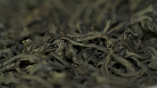 background texture of Sencha green tea - fresh, sweet, delicate tea. Black tea close up background. Heap of dry black tea ,texture. Macro shot