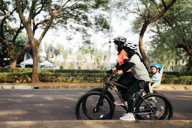 istock muslim woman riding bicycle 1415954997