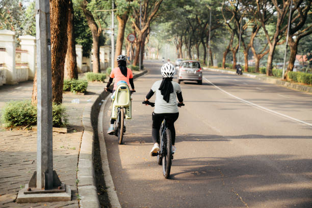 istock muslim woman riding bicycle 1415955004