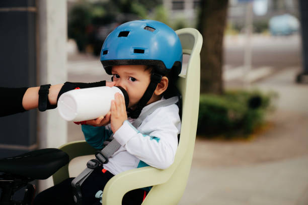 istock Baby  holding and drink the water bottle 1415955108