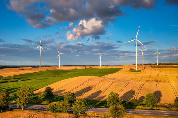 istock Wind turbines on the meadow over the blue sky 1415955447