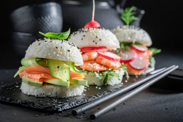 istock Delicious sushi burger with seafood and rice on strone plate. 1415957710