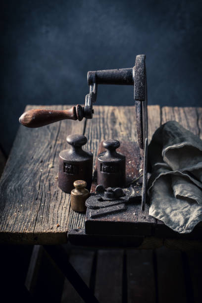 istock Homemade rustic old slicer and metal weights. 1415957848