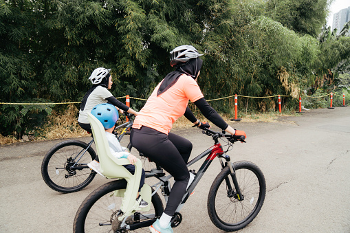 muslim woman riding bicycle