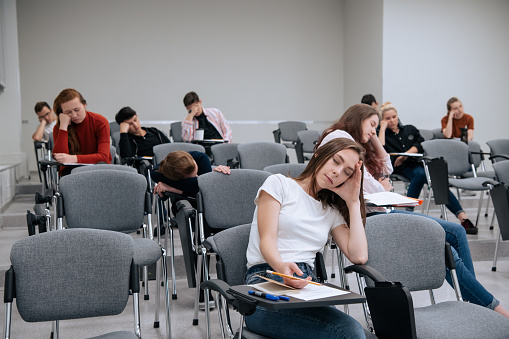 A break between classes in high school. Students rest and sleep in the classroom because of the large number of lessons and overwork.