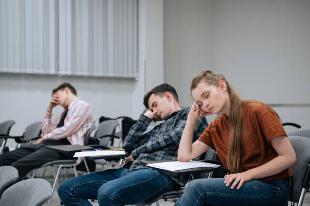 A break between classes in high school. Students rest and sleep in the classroom because of the large number of lessons and overwork stock photo