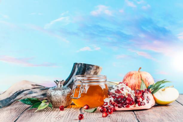 Rosh Hashanah Holiday Background Rosh Hashanah Holiday Background. Rosh hashanah (jewish holiday) concept: honey, apples and pomegranate. Space for text shana tova stock pictures, royalty-free photos & images
