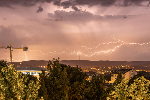 Massive Lightning Strike Over the City Suburbs Lights