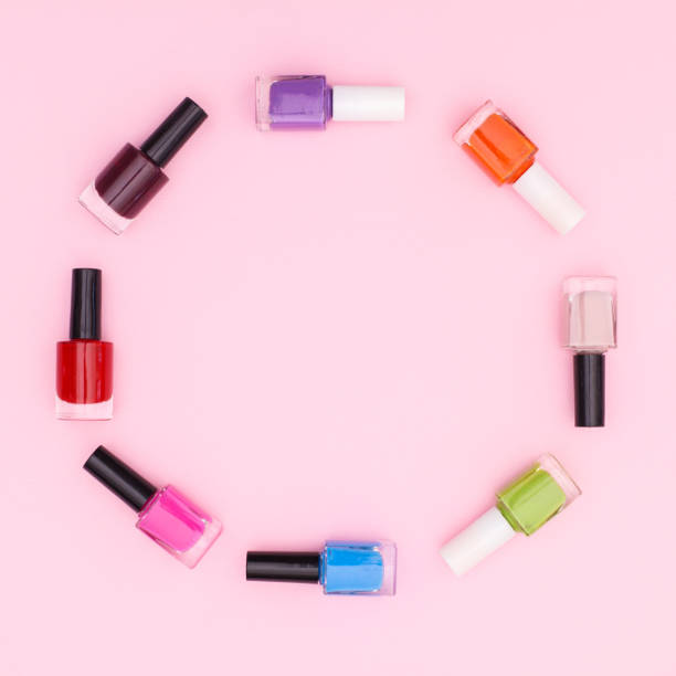 istock Colorful nail polish bottles oin circle make copy space frame on pastel pink backgorund. Flat lay 1415962834