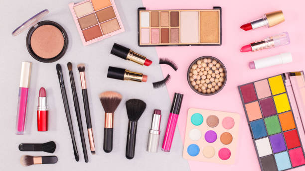 istock MAke up and cosmetics products pattern on grey and pastel pink background. Flat lay 1415963358