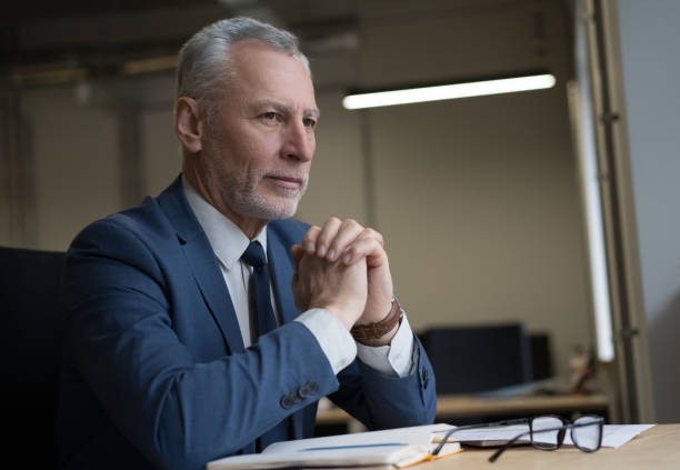 istock Pensive manager sitting in office 1415964252