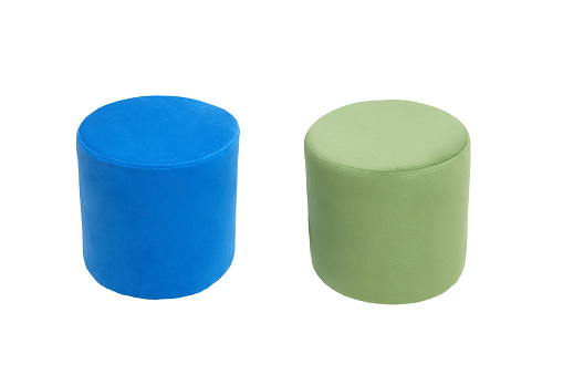 unusual modern green and blue cylindrical padded stools upholstered with soft fabric in strict style isolated on white background. Creative approach to making furniture in shape of cylinder