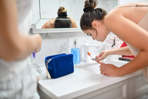 istock Female Beauty Spitting Toothpaste After Brushing Teeth 1415968059