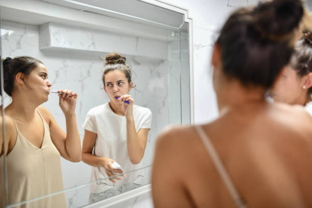 istock Funny Lesbian Females Staring At Each Other While Comparing Toothpastes 1415969137