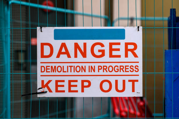 istock Danger Demolition in Progress Keep Out sign on metal construction fence 1415969475