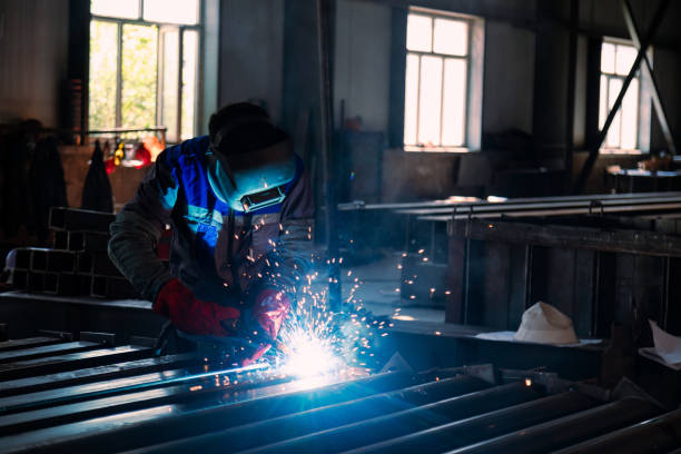 istock Industrial welder welding metal profiles 1415969521