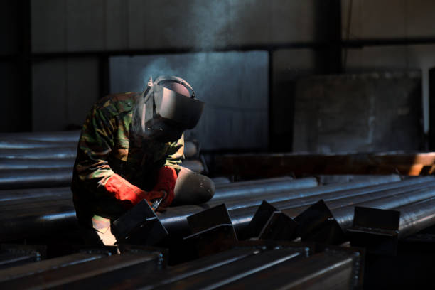 istock Industrial welder welding metal profiles 1415969774