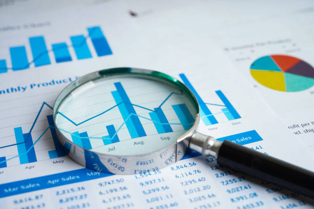 istock Magnifying glass on charts graphs paper. Financial development, Banking Account, Statistics, Investment Analytic research data economy. 1415969789