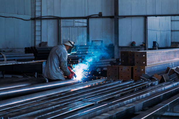 istock Industrial welder welding metal profiles 1415969822