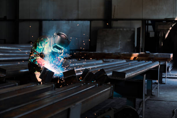 istock Industrial welder welding metal profiles 1415970024