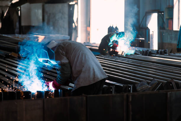 istock Industrial welder welding metal profiles 1415970107