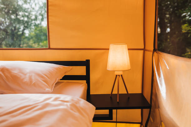 istock Interior of Cozy open glamping tent with light inside during dusk. Luxury camping tent for outdoor summer holiday and vacation. Lifestyle concept 1415971221