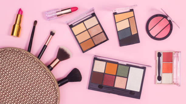 istock Make up products in cosmetics kit on pastel pink background. Flat lay 1415971274