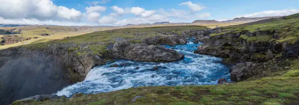 Photo of Panoramic Beautiful lush green Landscape of Skoga river valley cascades near Skogafoss waterfall and Skogar end of Fimmvorduhals hiking trail. South Iceland, Summer blue sky