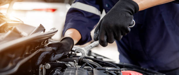istock Car care maintenance and servicing, Close-up hand technician auto mechanic using the wrench to repairing change spare part car engine problem and insurance service support. 1415976563