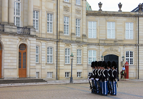 Copenhagen, Denmark - July 29, 2022: Royal guardsmen in square of Royal castle Amalienborg.
