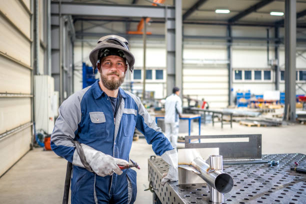 istock Young adult bearded Caucasian man standing in workshop 1415978424