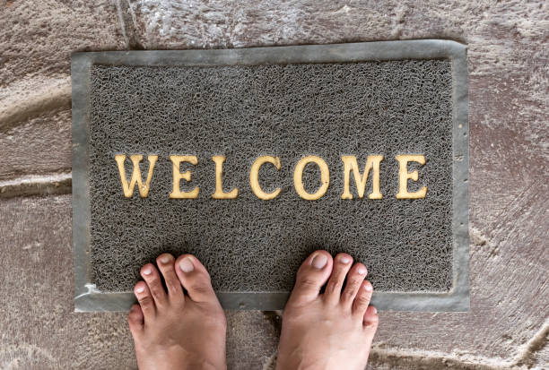 istock Top view of foot on welcome mat 1415981312